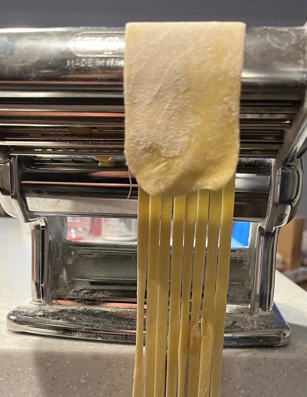 pasta being cut into noodles